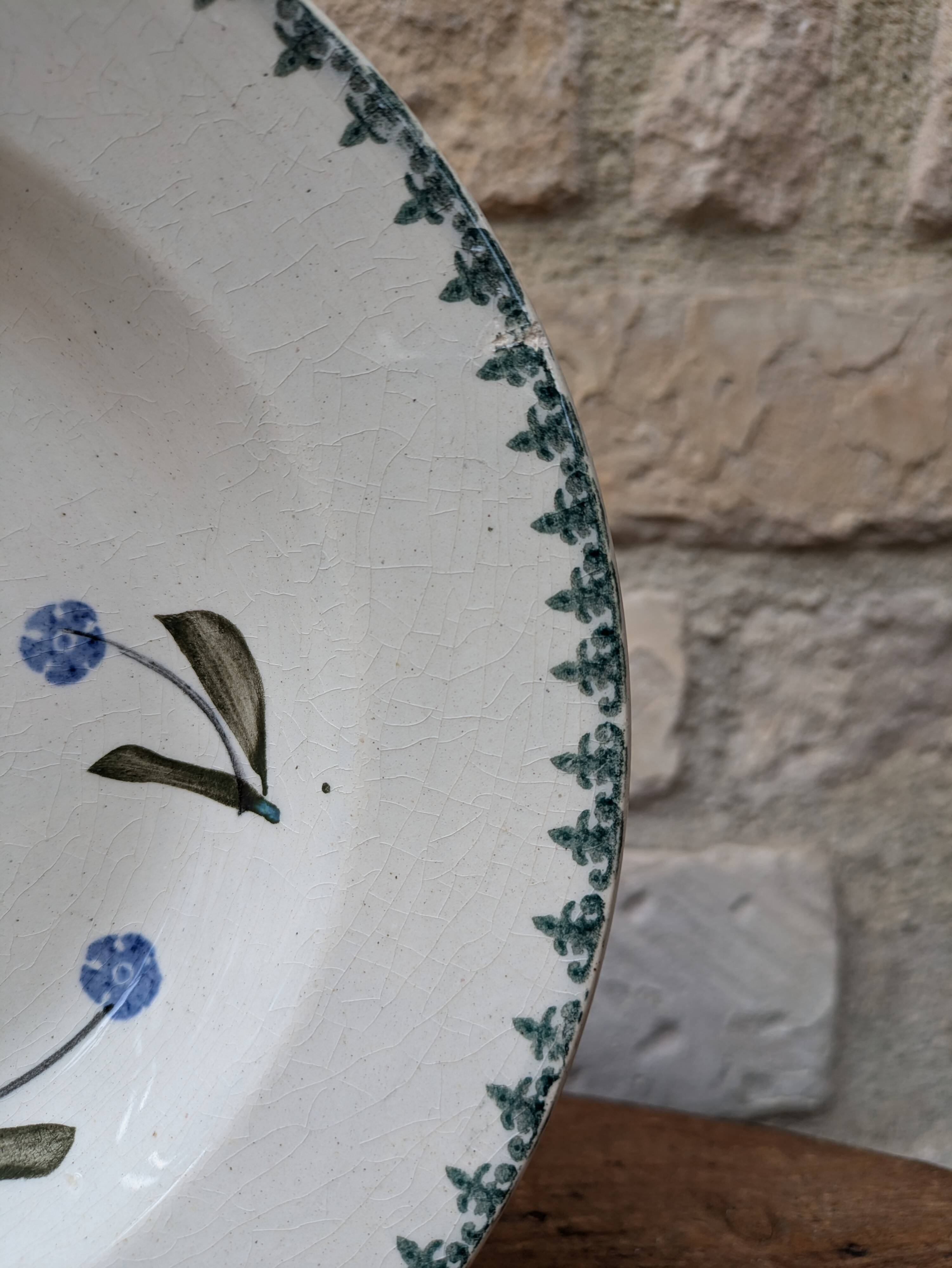 Old deep iron earth plate with blue flower pattern