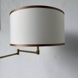 Floor lamp with articulated arm in brass-plated metal