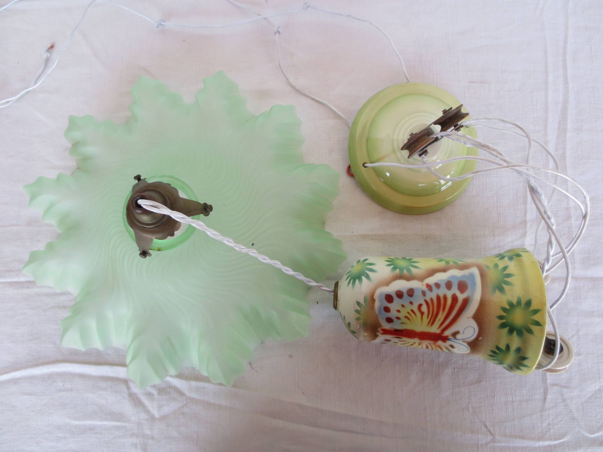 "Very old light fixture" with a "rise and fall" counterweight adorned with butterflies.