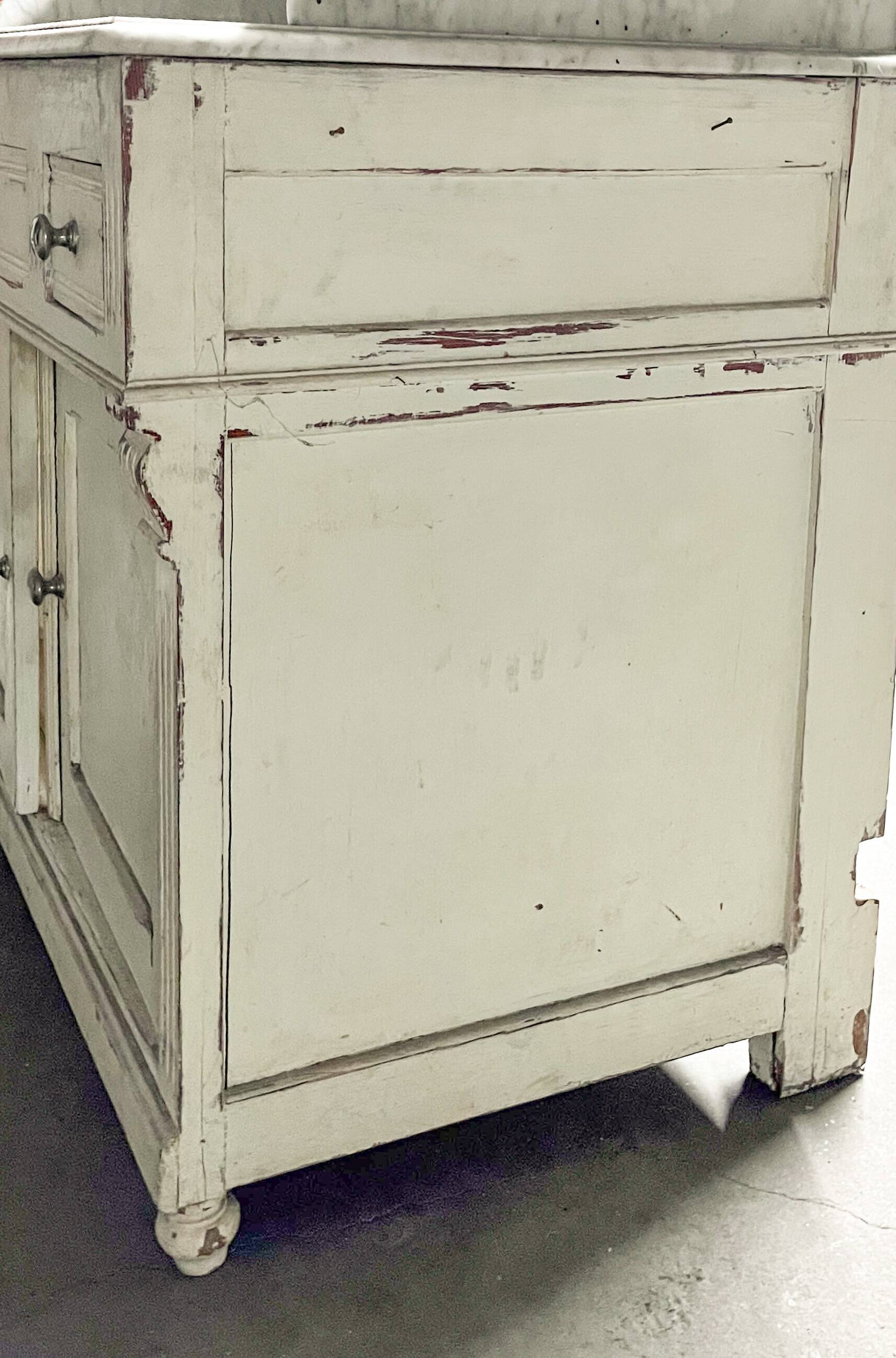Antique wooden bathroom cabinet with painted finish and white marble.
