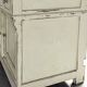 Antique wooden bathroom cabinet with painted finish and white marble.