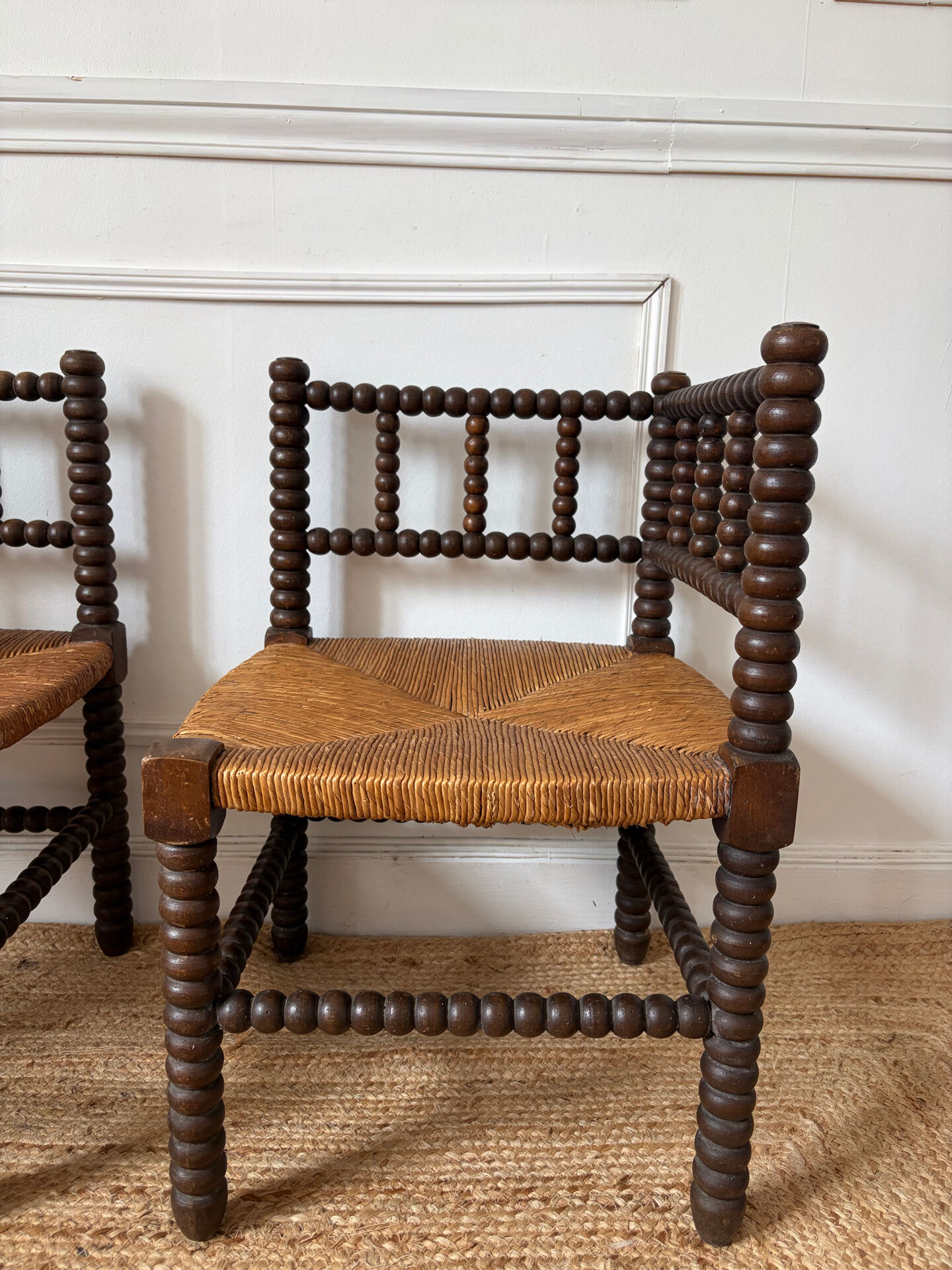 Pair of rush-seated chairs by the fireside "bobbin"
