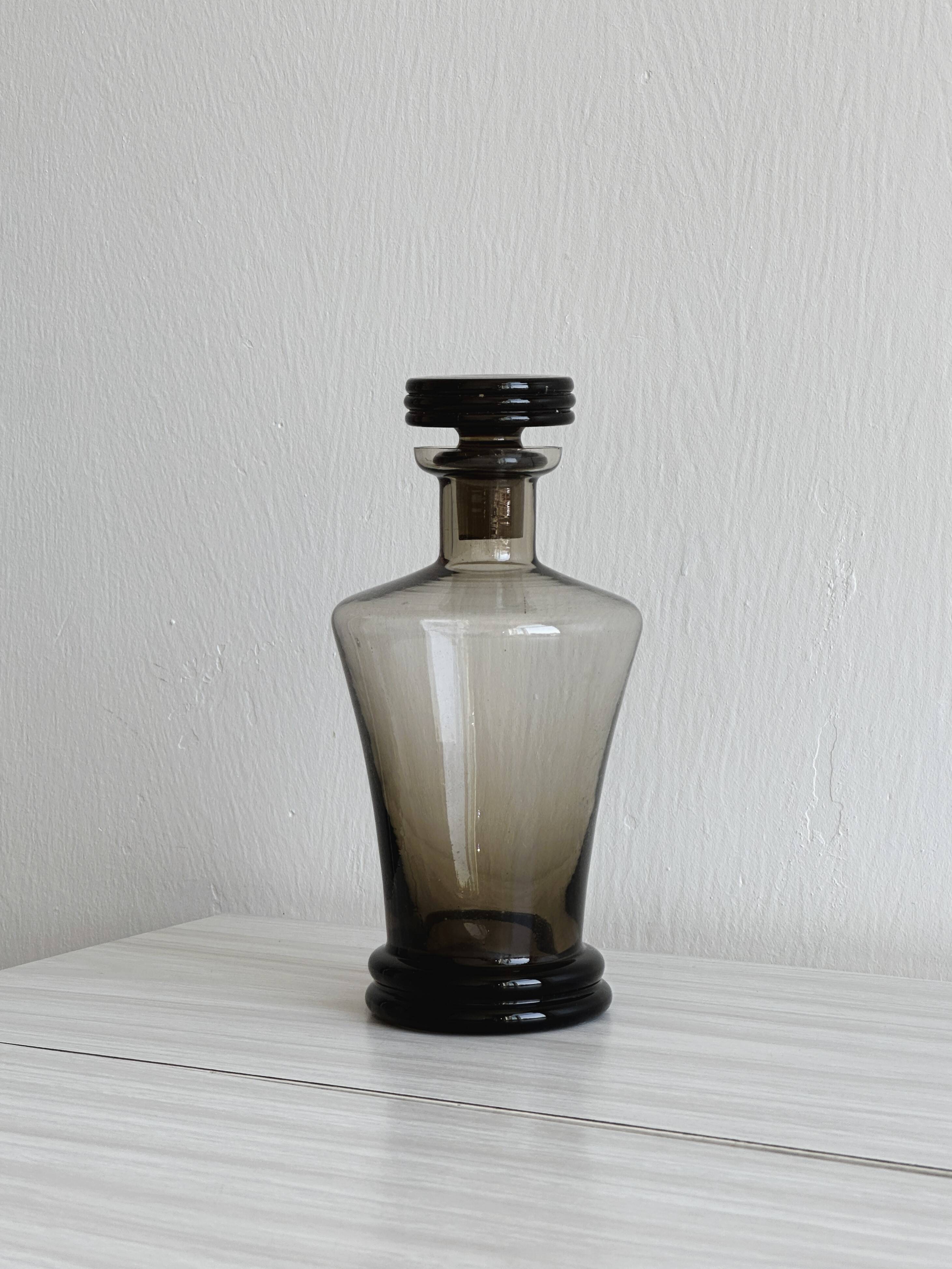 Smoked glass bottle, sculpted stopper