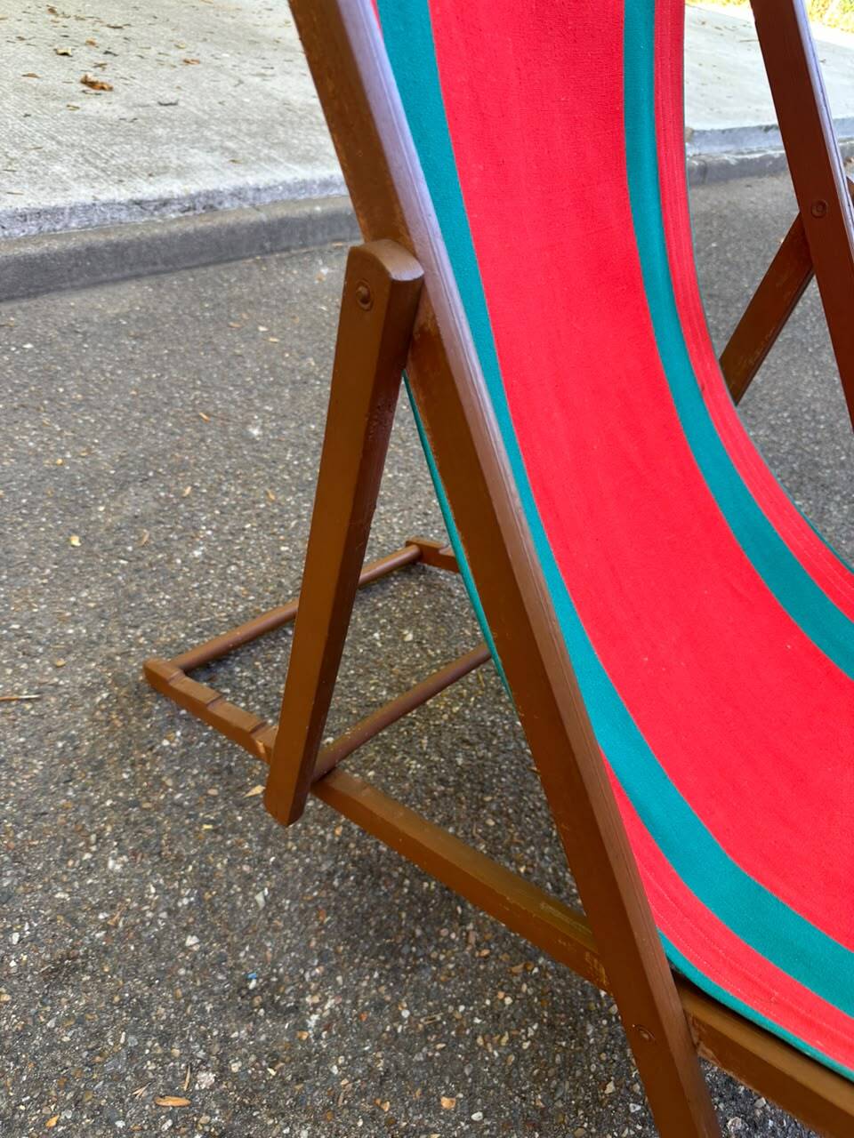 Vintage folding wooden deck chair with red and green striped canvas from the 1970s.