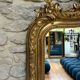 Antique mirror 183.5/116cm with pediments and pearl detailing in gold leaf.