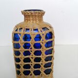 Blue bottle covered with wicker