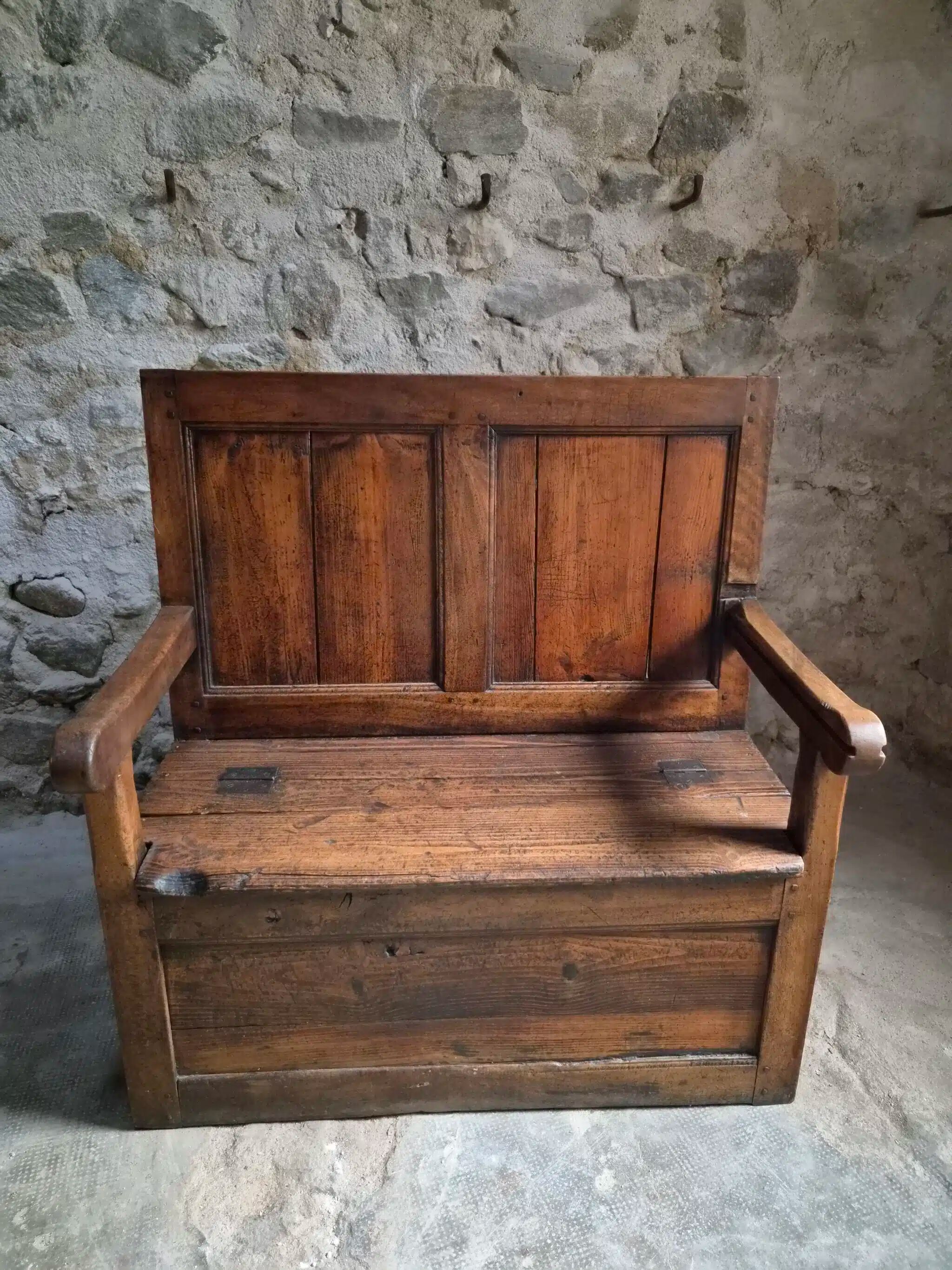 Rustic French antique storage bench from the 18th century in walnut and pine.