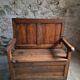 Rustic French antique storage bench from the 18th century in walnut and pine.