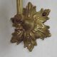 Simple wall sconce in French Art Nouveau bronze with a white glass shade featuring patterns.