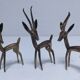 five vintage brass sculptures of gazelles, antelopes, and a giraffe