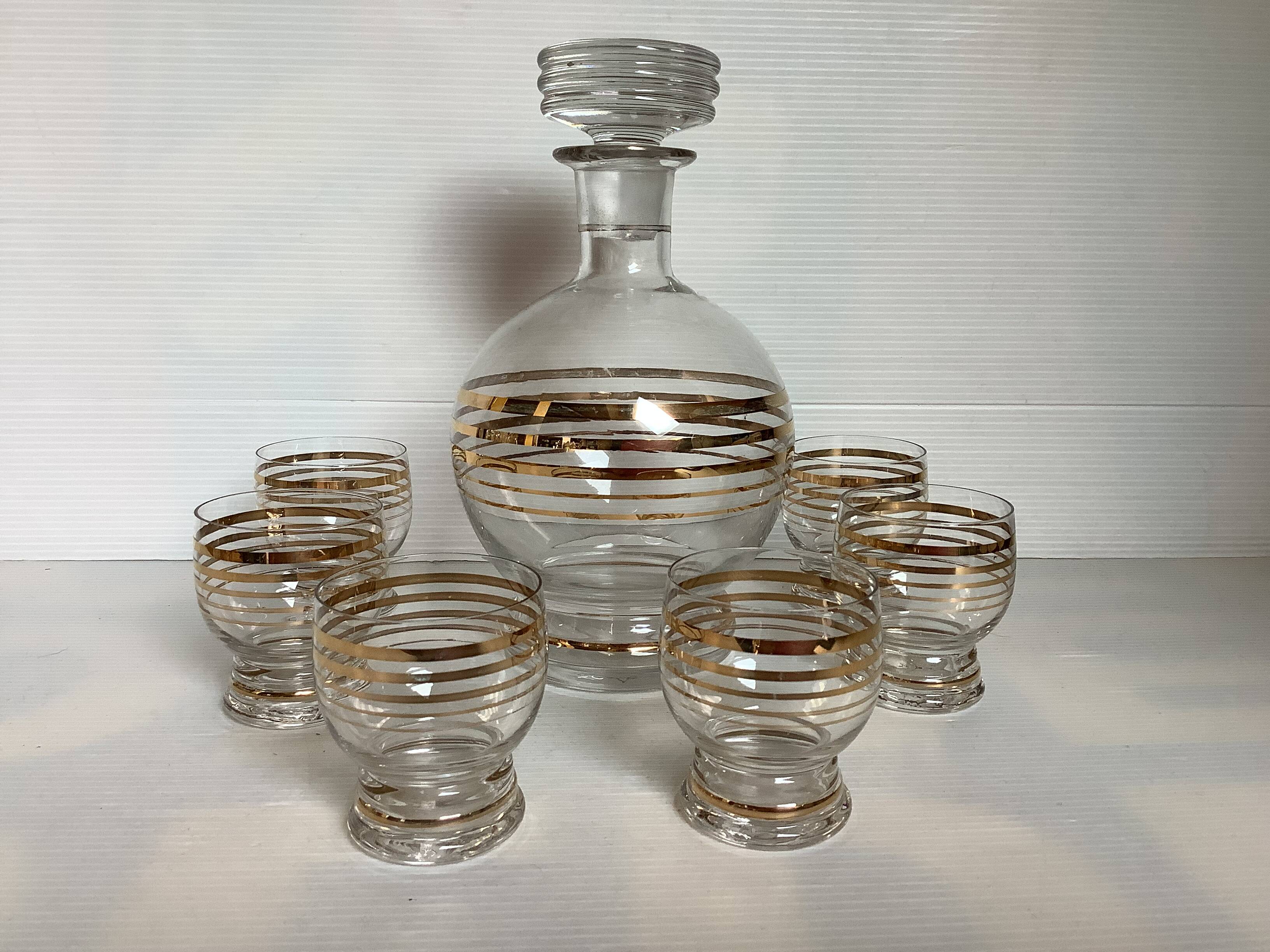 Antique liqueur set with a gold rim.