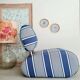 Curved armchair with blue and white stripes