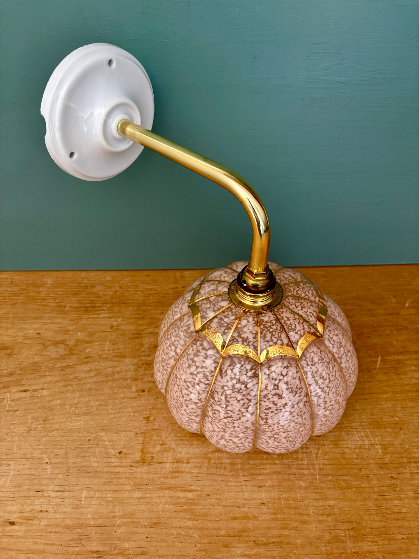 Vintage glass wall light with a pink and gold Clichy globe.