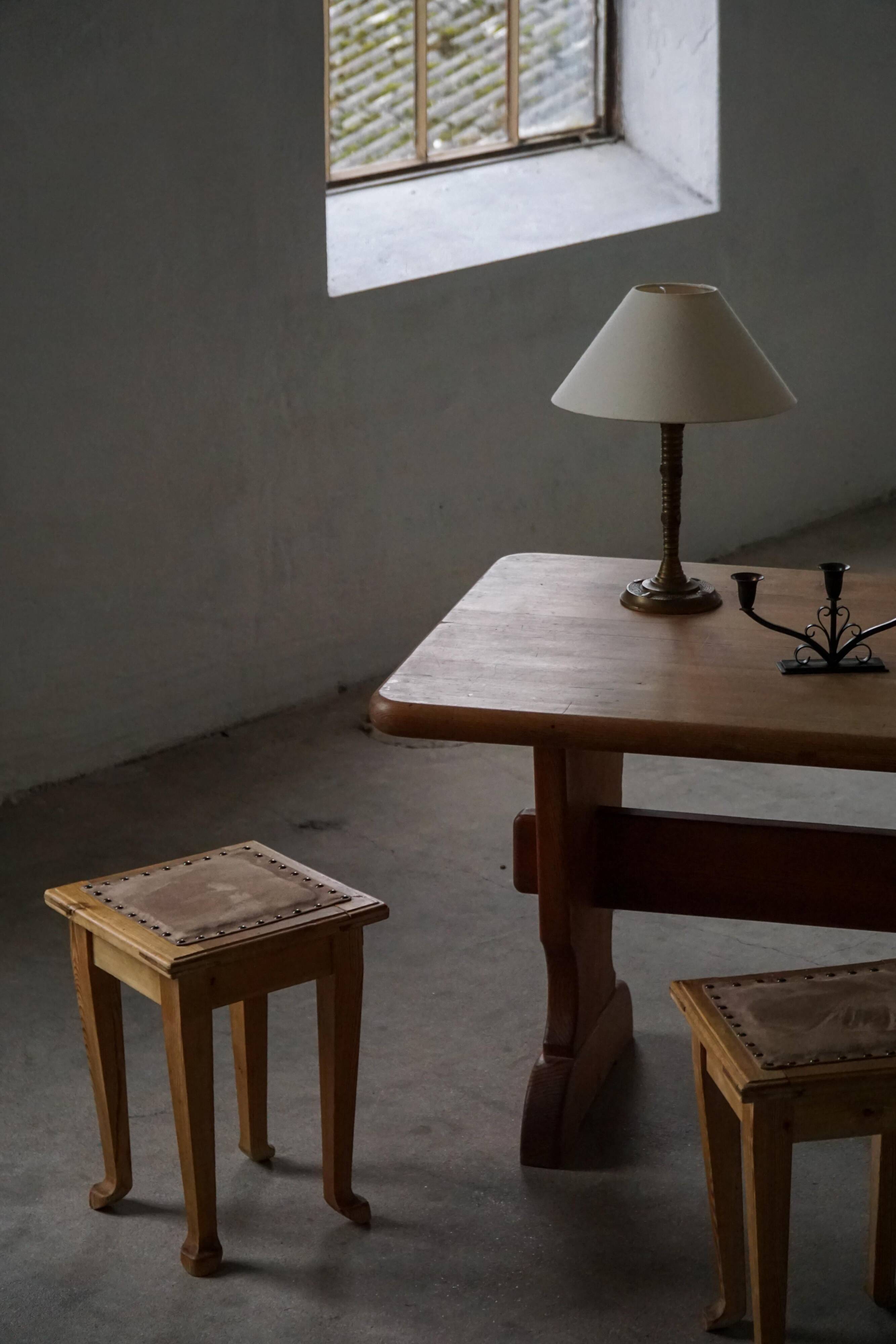 A pair of antique Danish pine stools from the late 19th century.