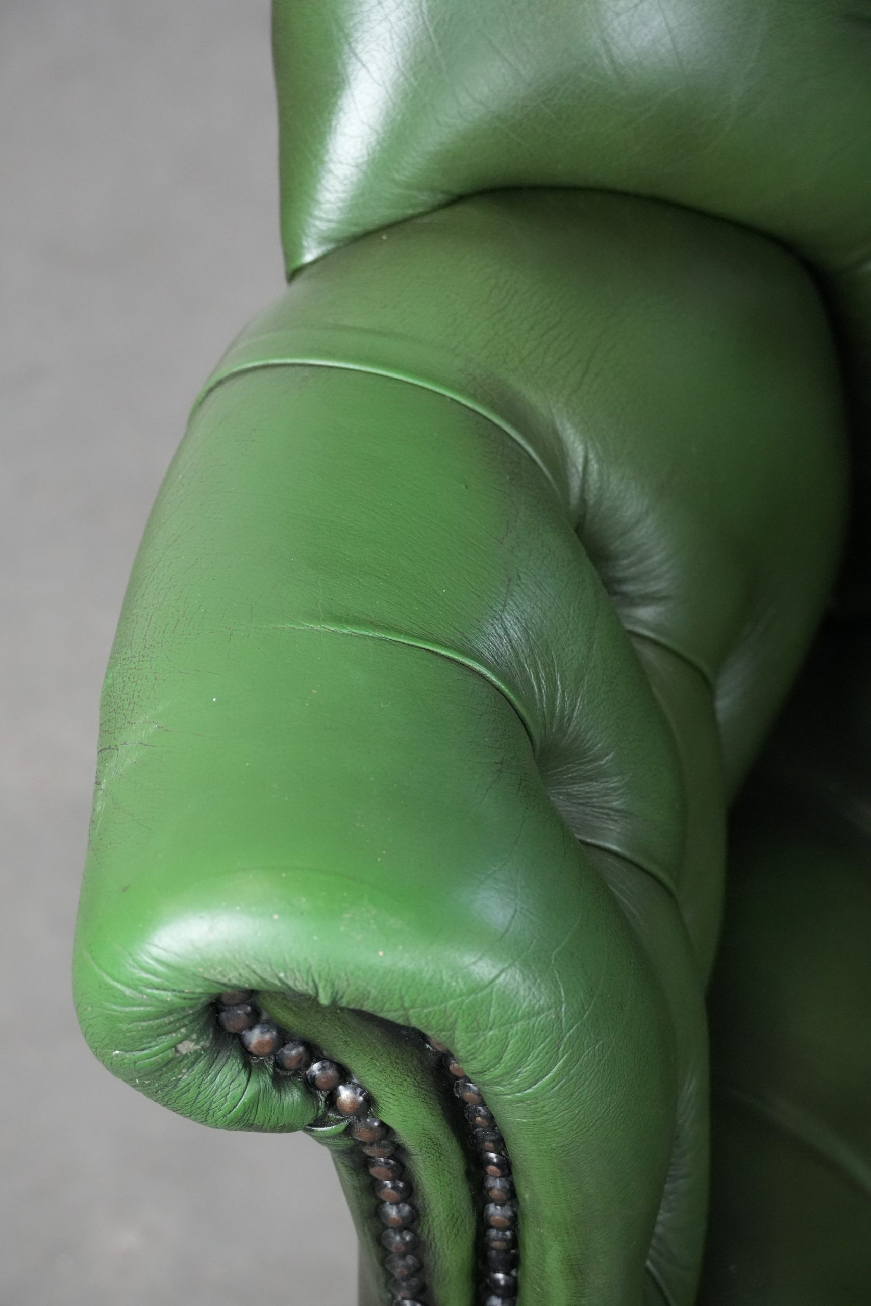 Large green cowhide Chesterfield office chair in English style on wheels