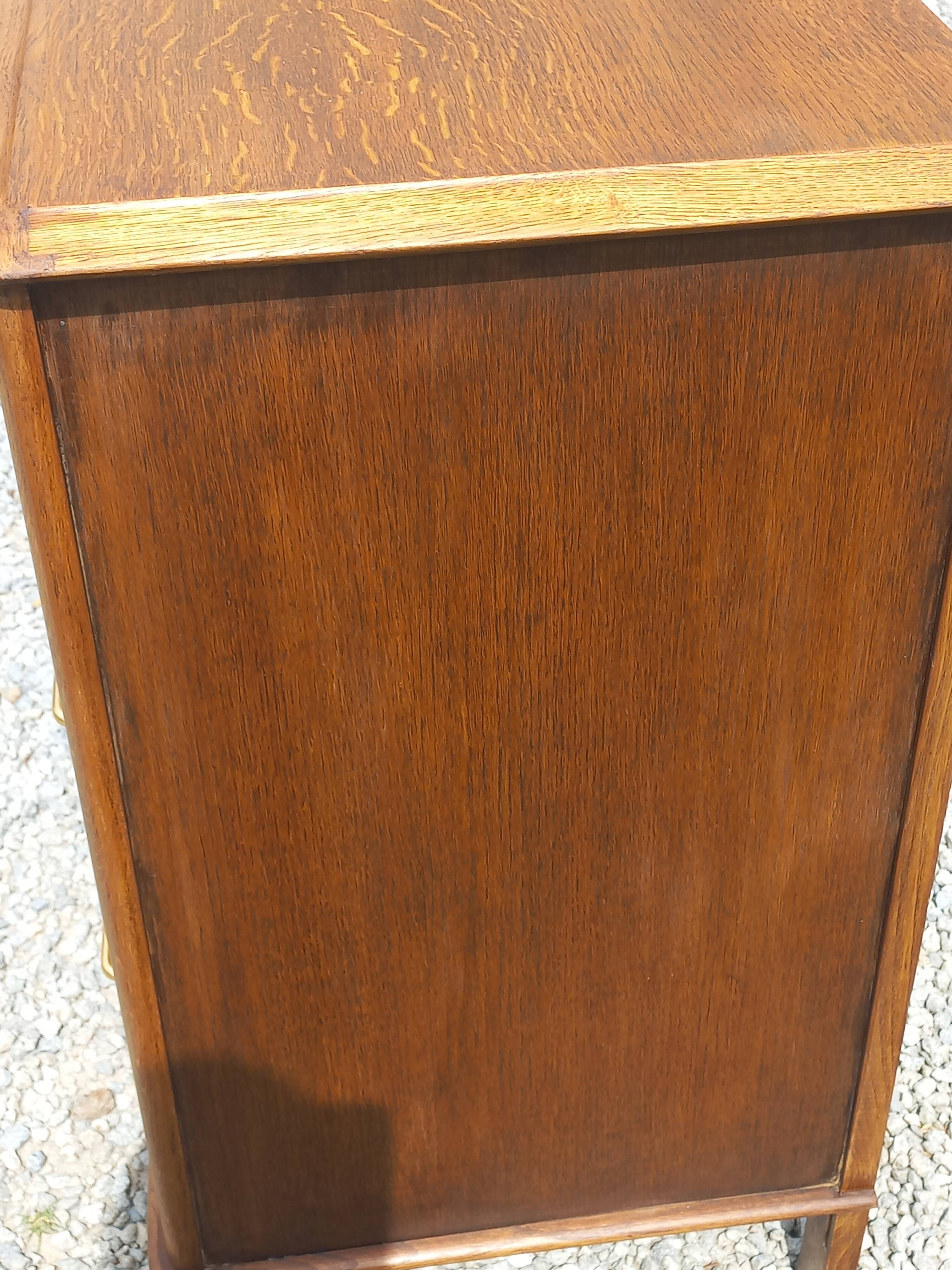 Vintage oak commode with tapered legs from the 1950s.