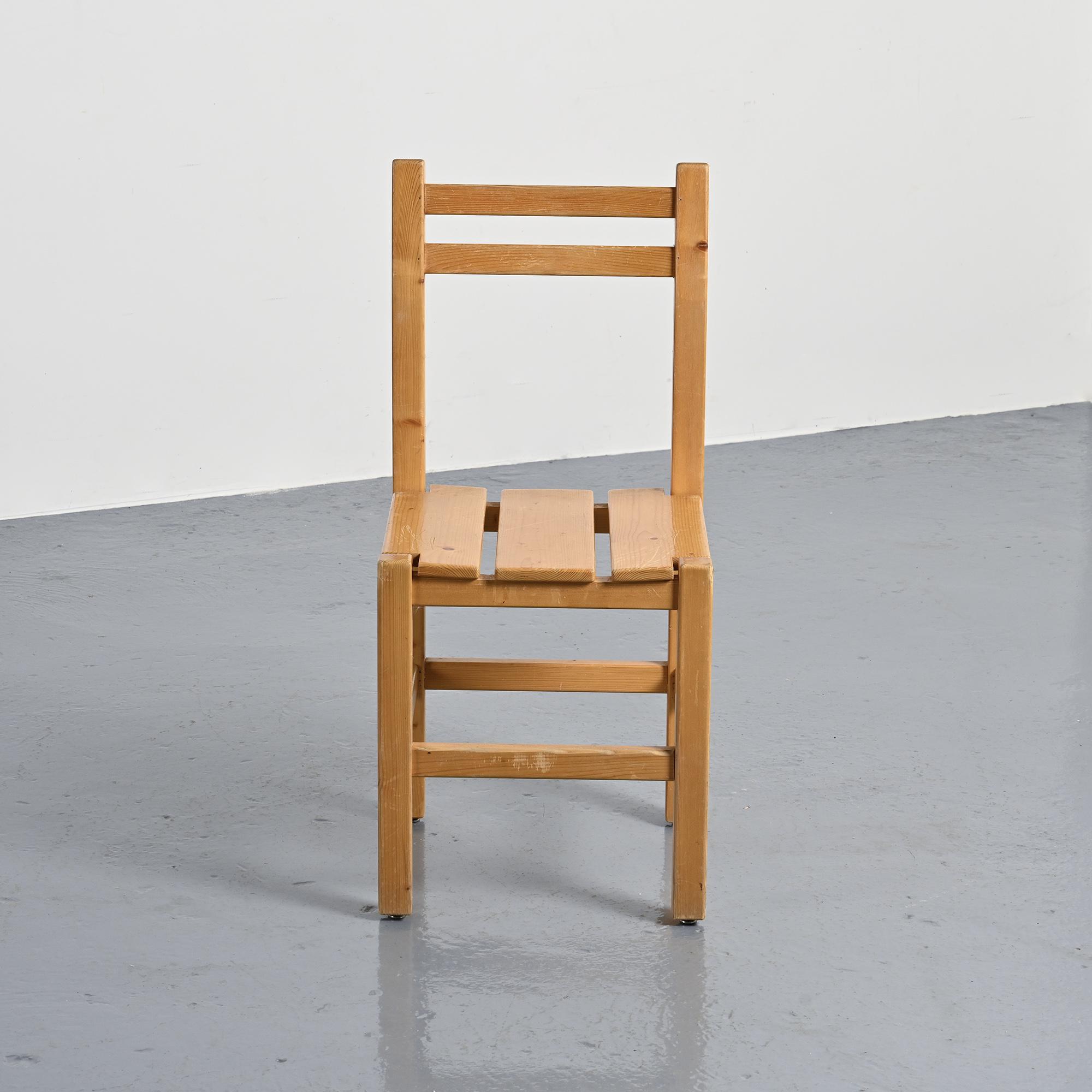 Set of four solid pine chairs by Maison Regain.