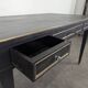 Large flat desk in Louis XVI style, black lacquered with gold highlights.