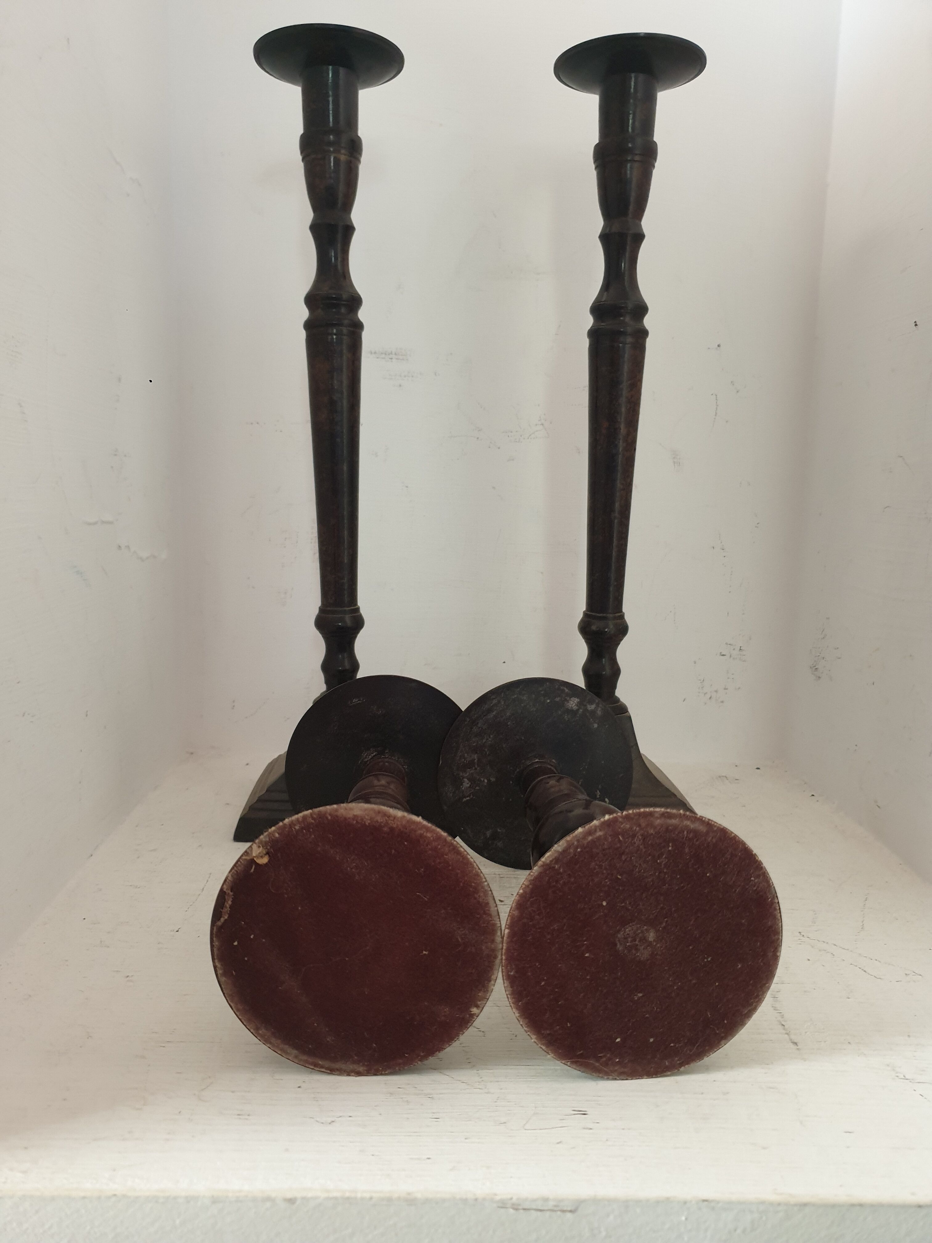 Two pairs of patinated brass candle holders