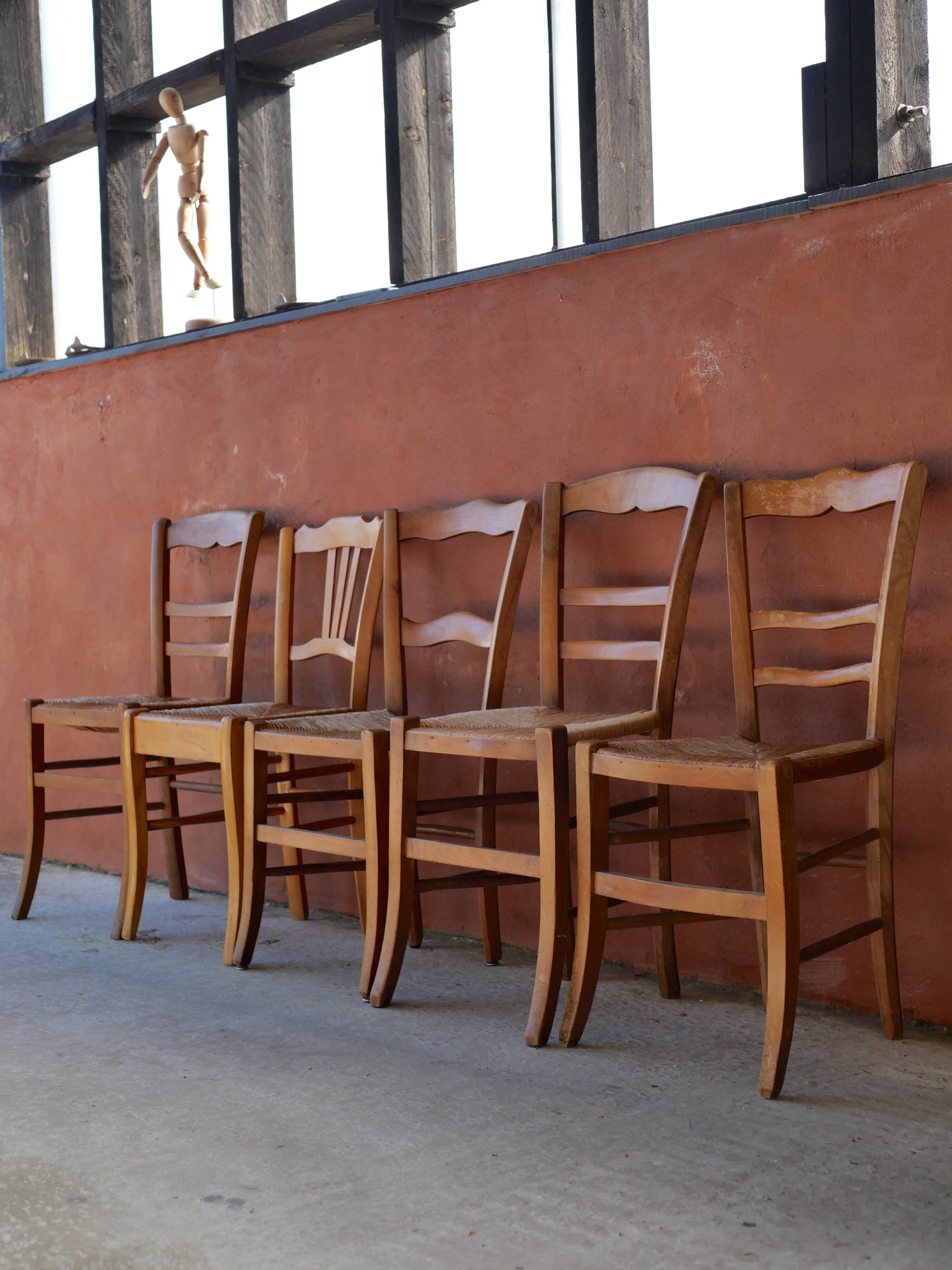 Set of 5 mismatched straw chairs.