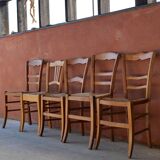 Set of 5 mismatched straw chairs.