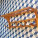 Curved wooden coat rack with shelf
