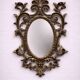Antique Louis XV style mirror, richly carved with decorations of scrolls, shells, and foliage.