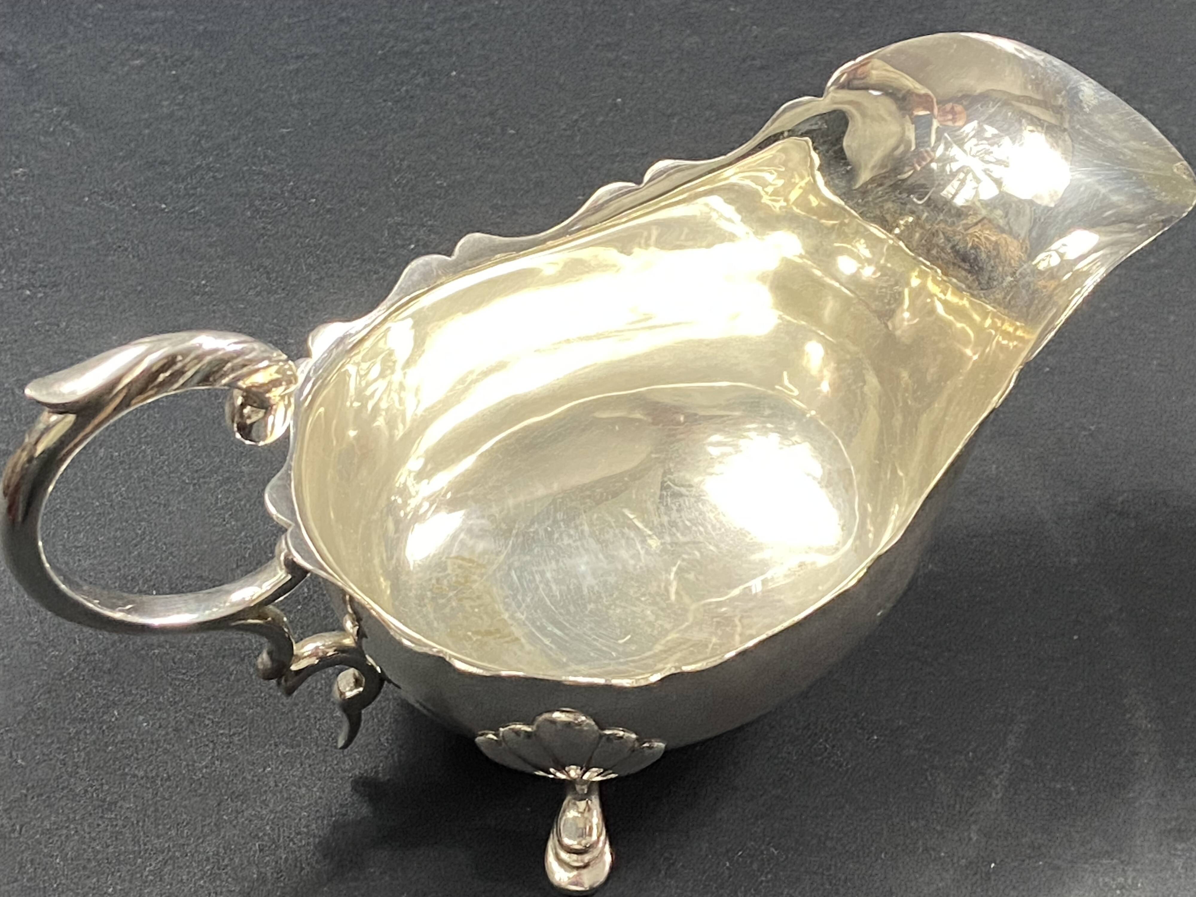 English George III style silver plated tripod sauce boat
