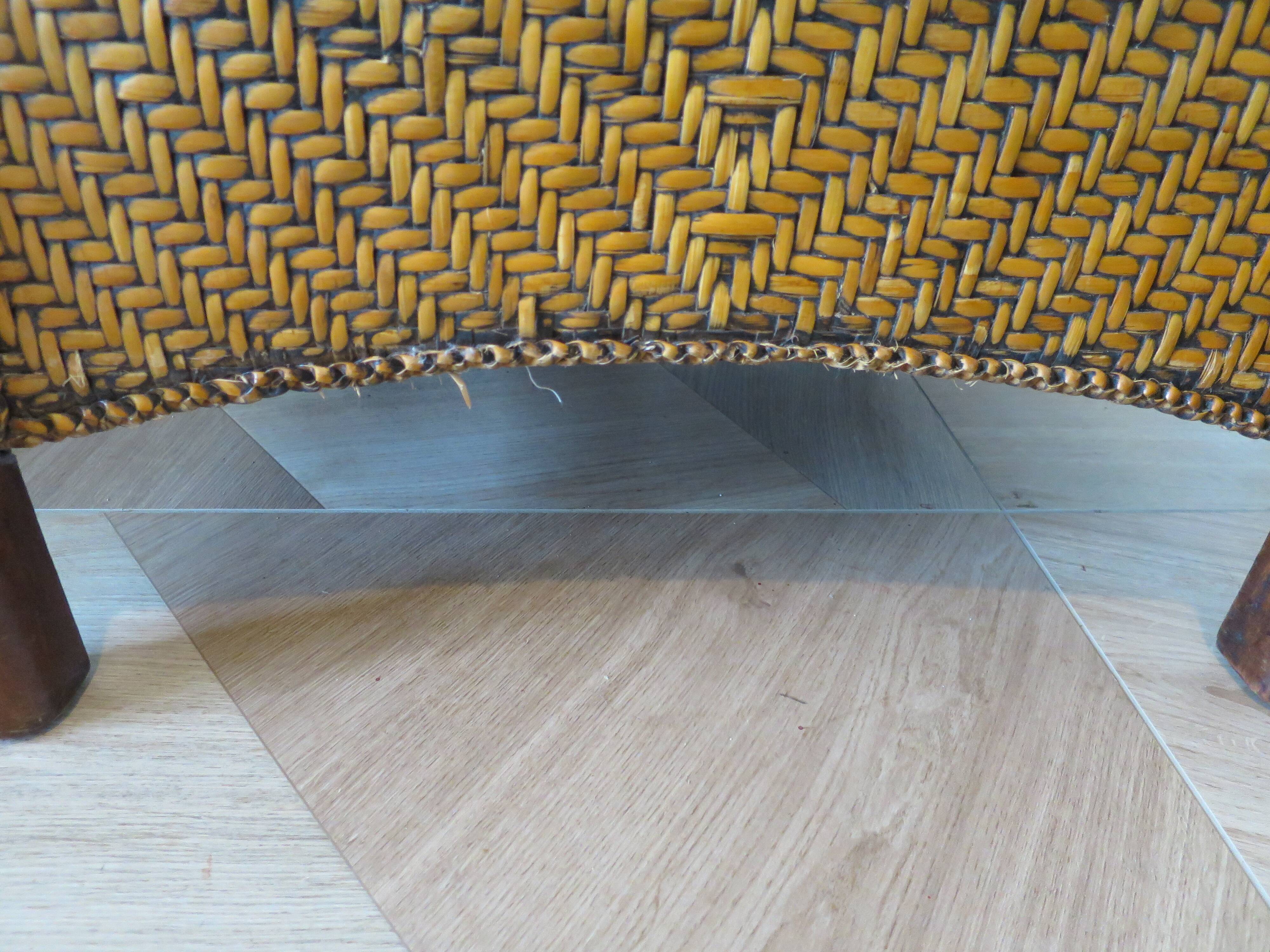 Colonial style armchair in woven rattan and exotic wood