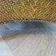 Colonial style armchair in woven rattan and exotic wood