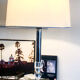 Silver floor lamp with a straight shade.
