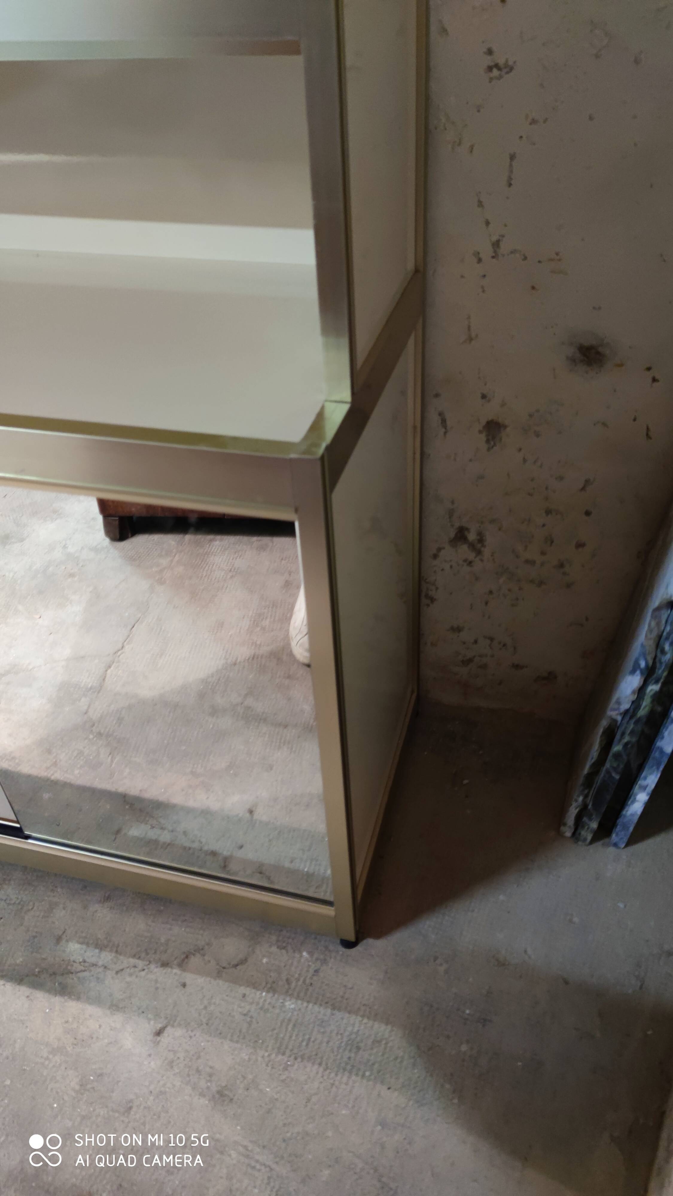 Ivory-colored and matte gold anodized aluminum display bookcase