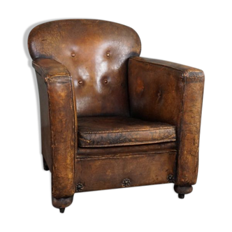 Fauteuil ancien en cuir de mouton