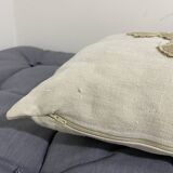 Cushion in vintage fabric with ornamentation