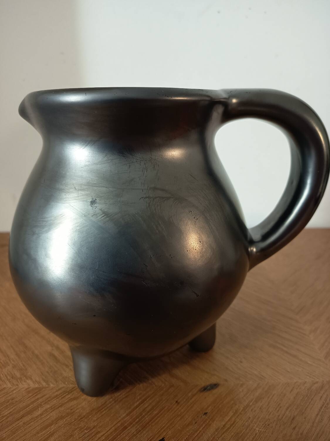 Black ceramic tripod jug