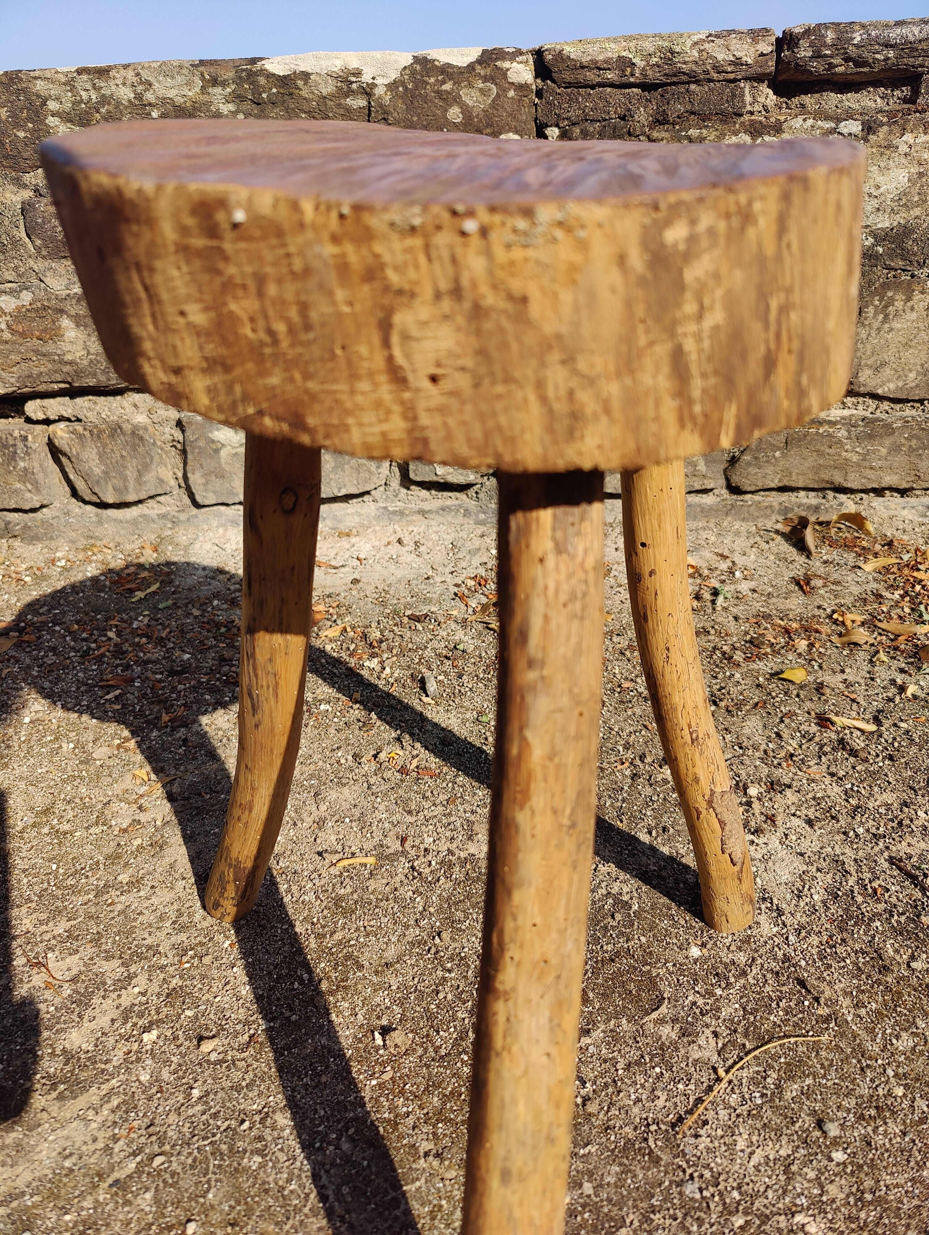 Rustic three-legged stool in minimalist wood in the style of Touret.