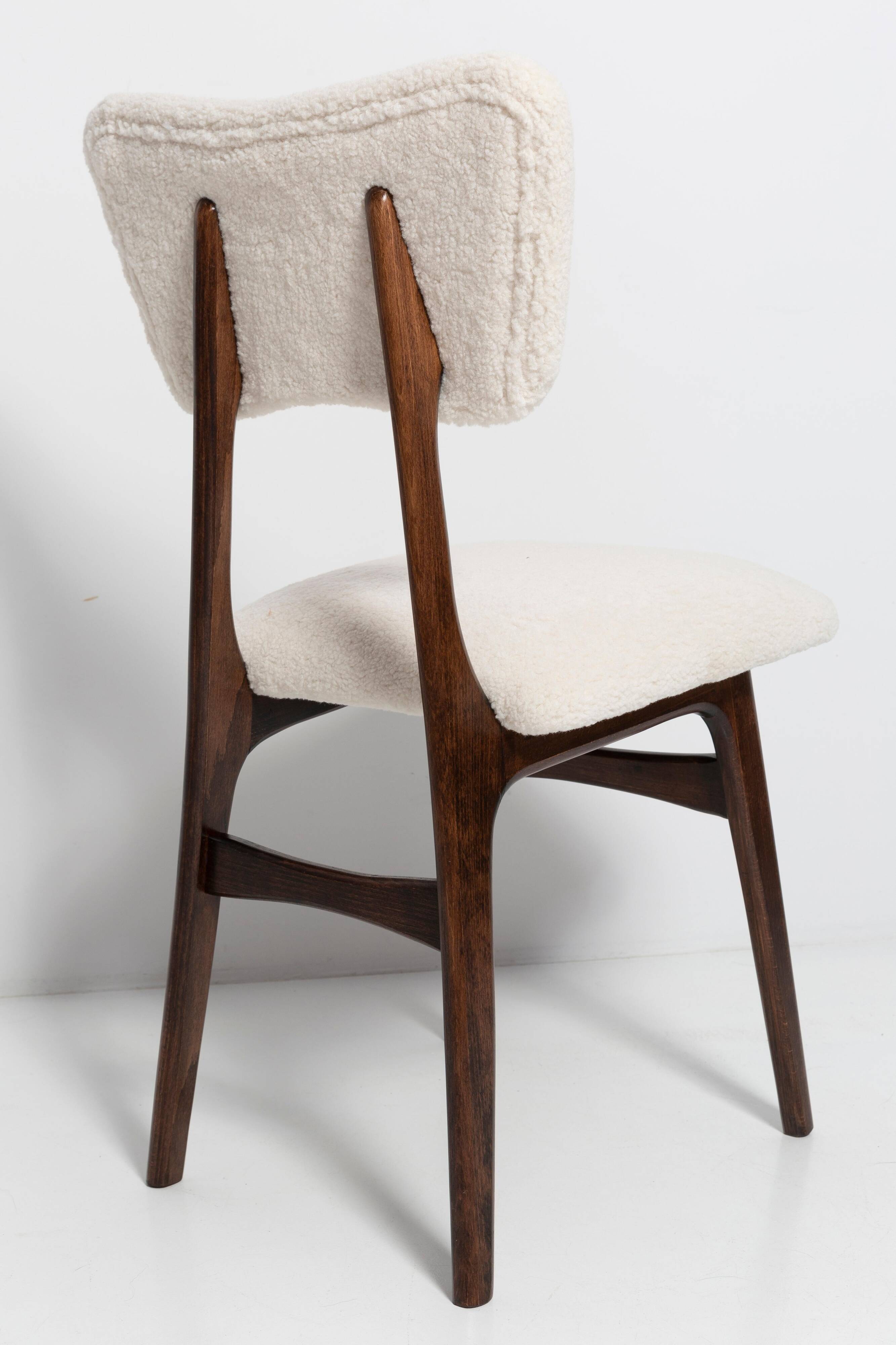 20th-century walnut and light cream boucle butterfly chair, Europe, 1960.