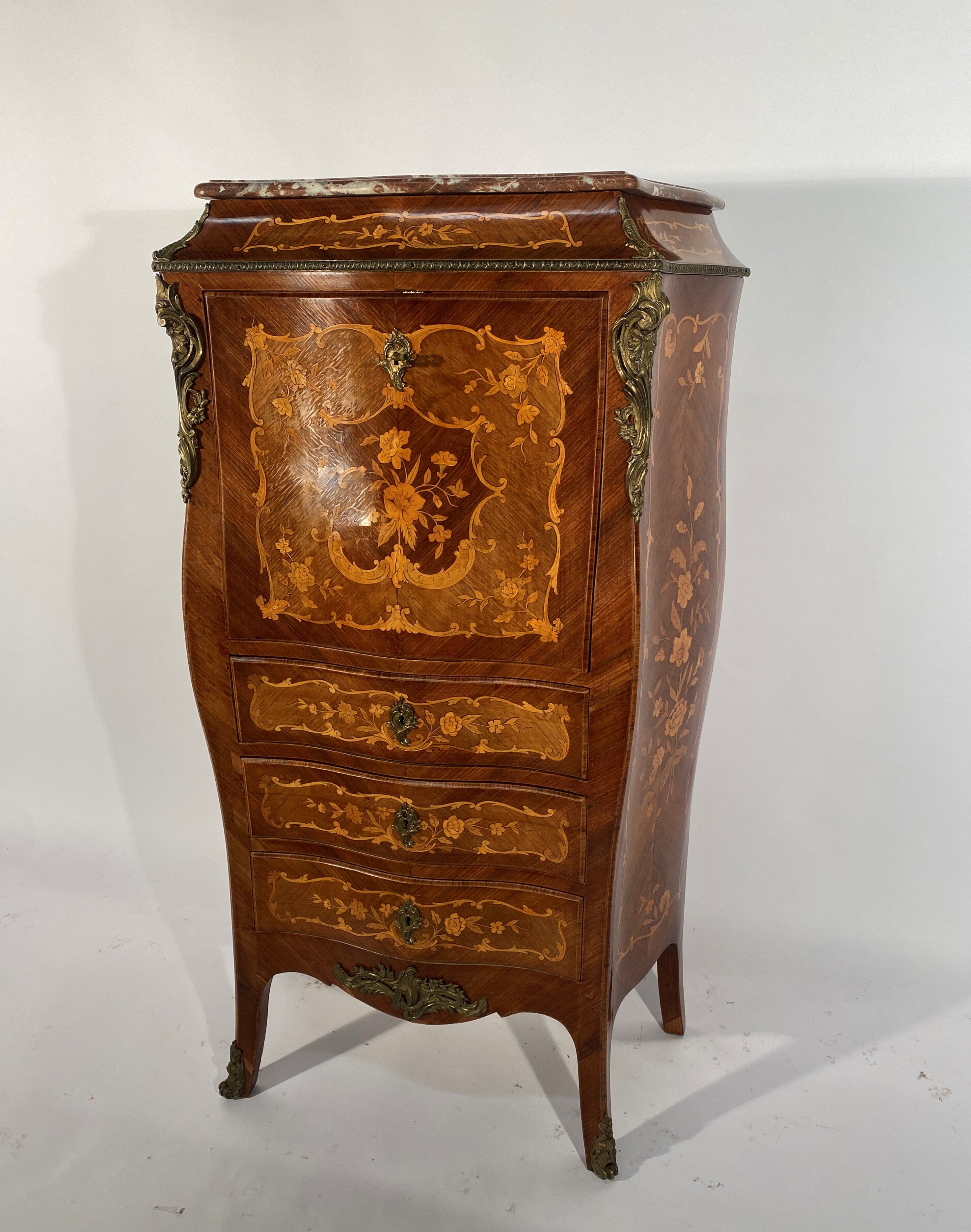 Curved secretary and inlaid with floral branches in Louis XV style