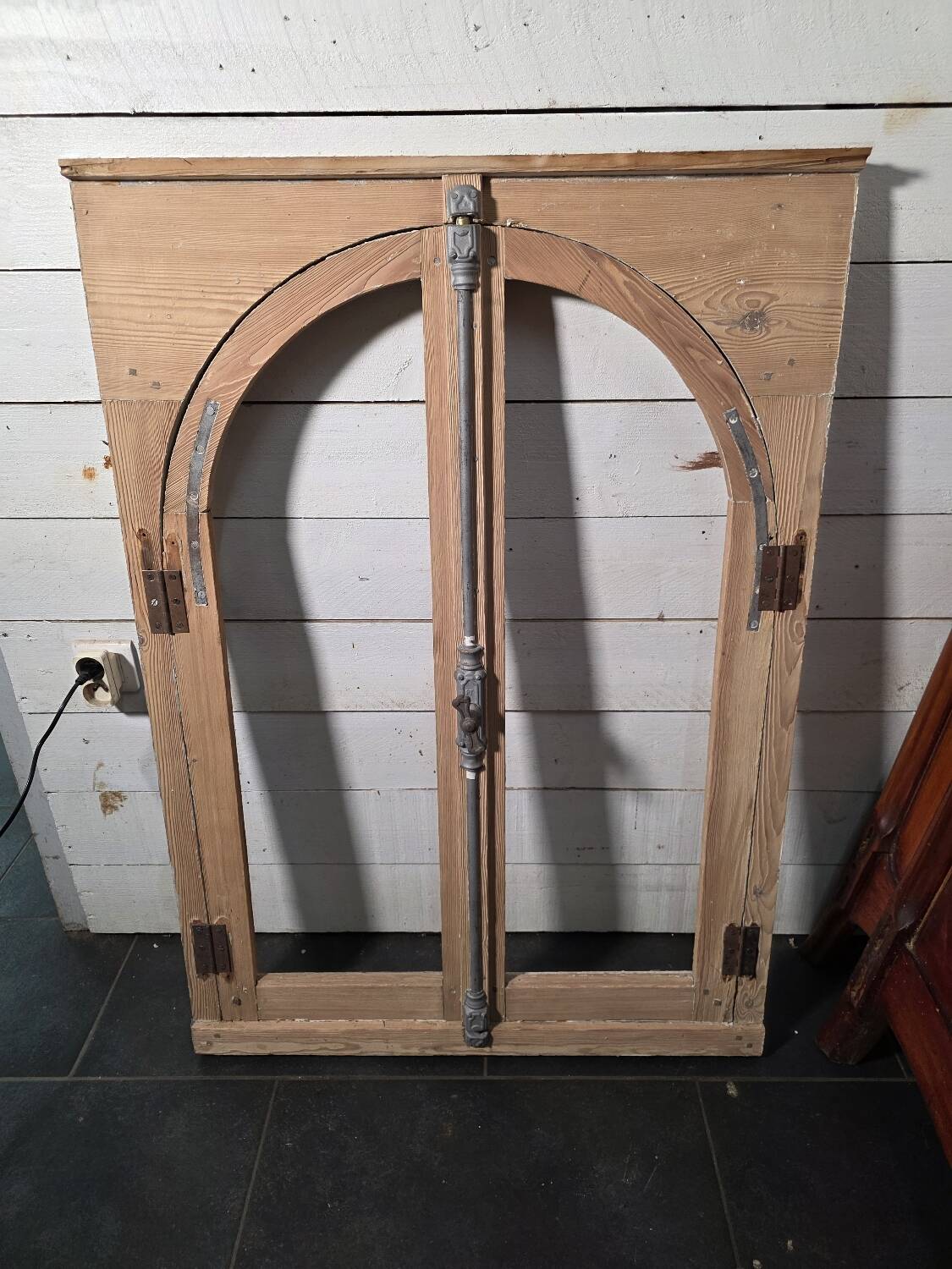Old arched window made of fir wood