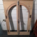Old arched window made of fir wood