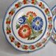 Pair of Henriot Quimper plates decorated with flower, 24 cm