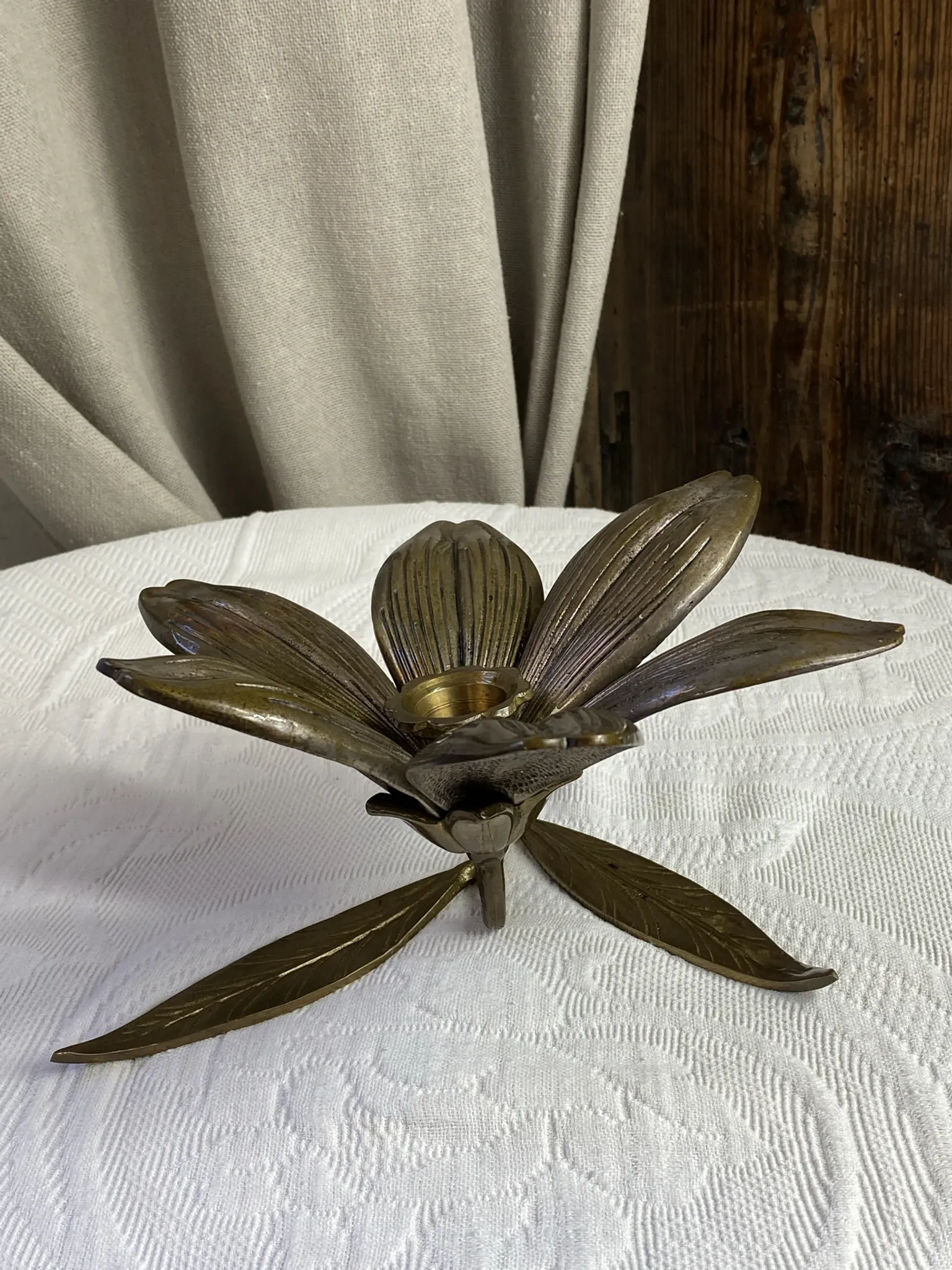Flower candlestick and removable ashtrays in solid brass.