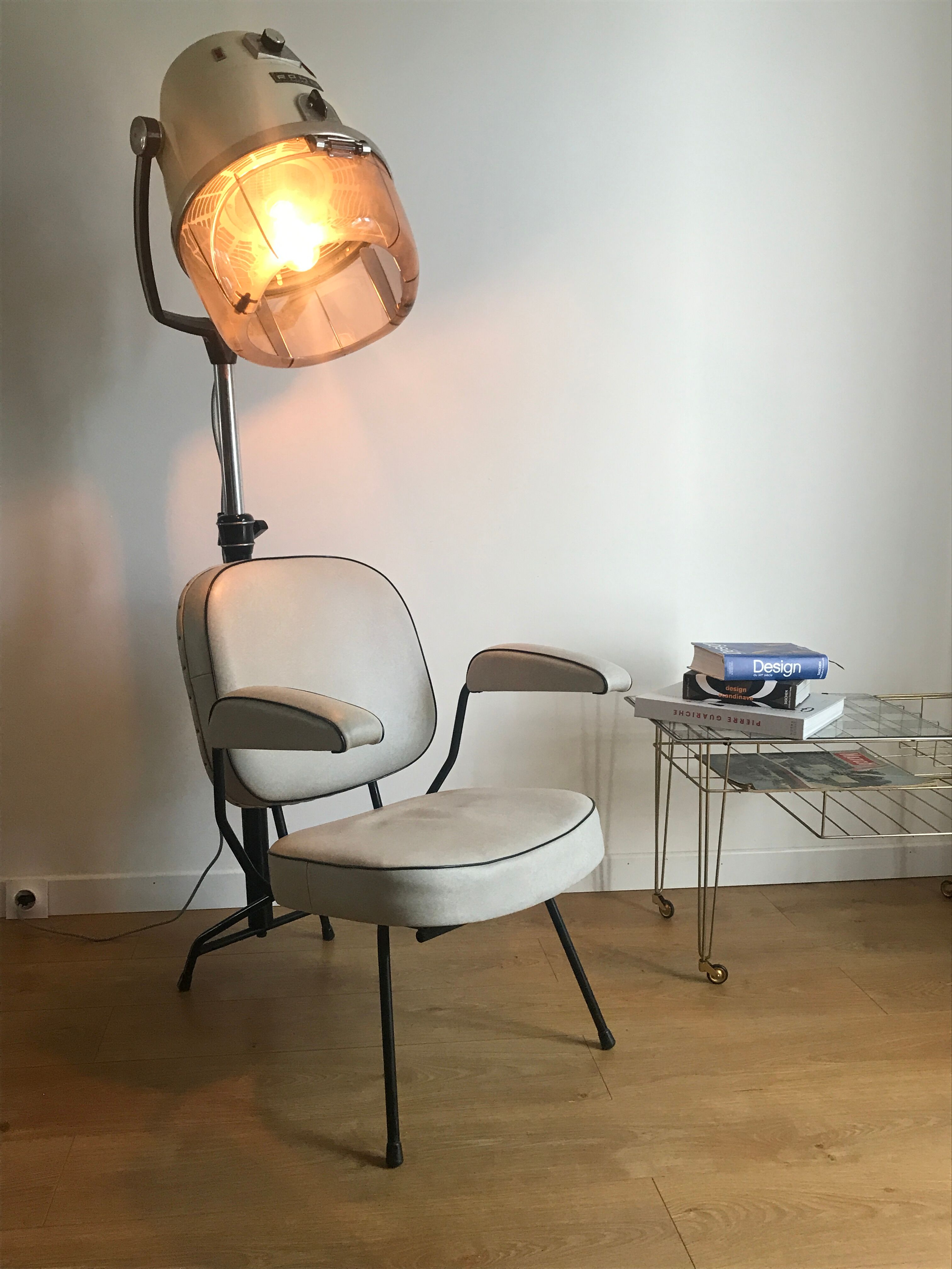 Vintage hairdresser's armchair with helmet transformed into a lamp