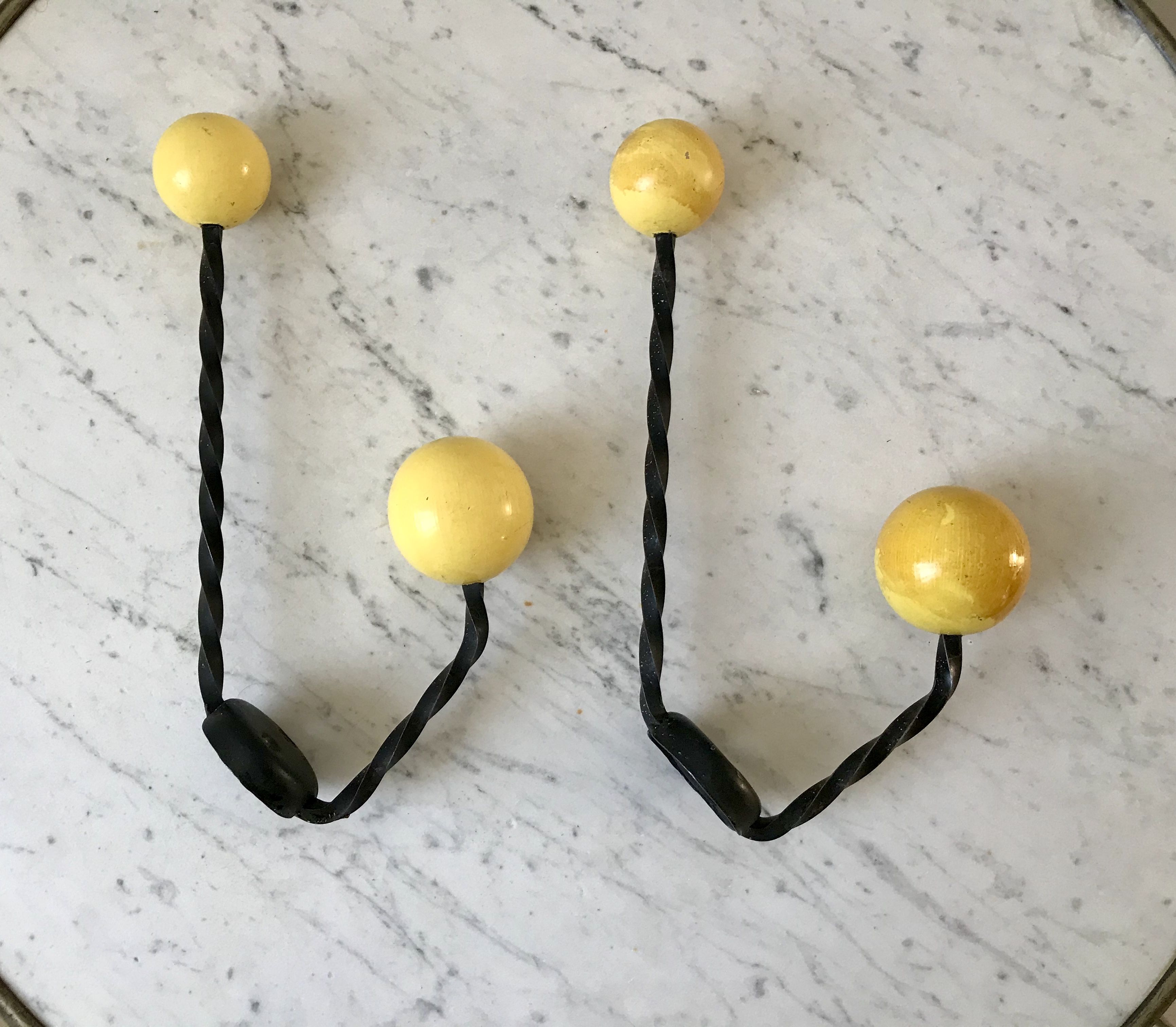 Duo of hooks balls in yellow wood and black iron 60s