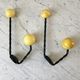 Duo of hooks balls in yellow wood and black iron 60s