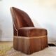 Brown velvet crapaud armchair with fringes and sculpted legs.