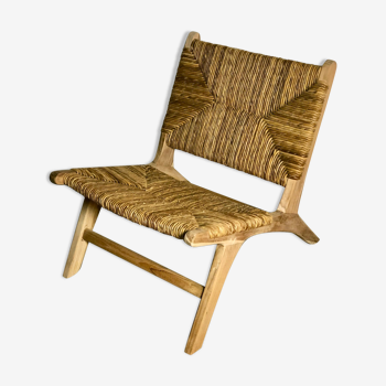 Low armchair in raw wood with seat and mulched backrest