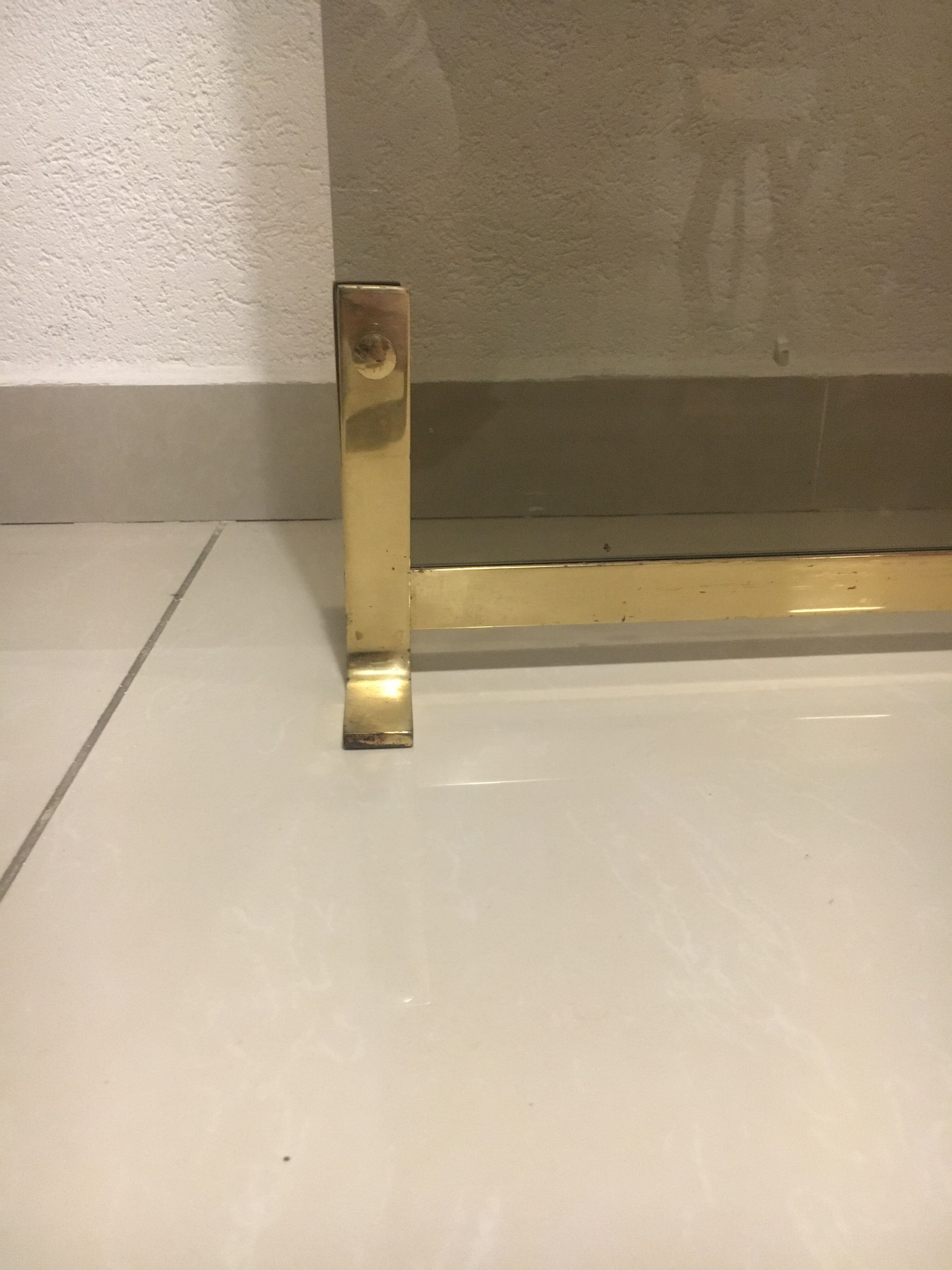 Fireplace screen in smoked glass and brass