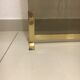 Fireplace screen in smoked glass and brass