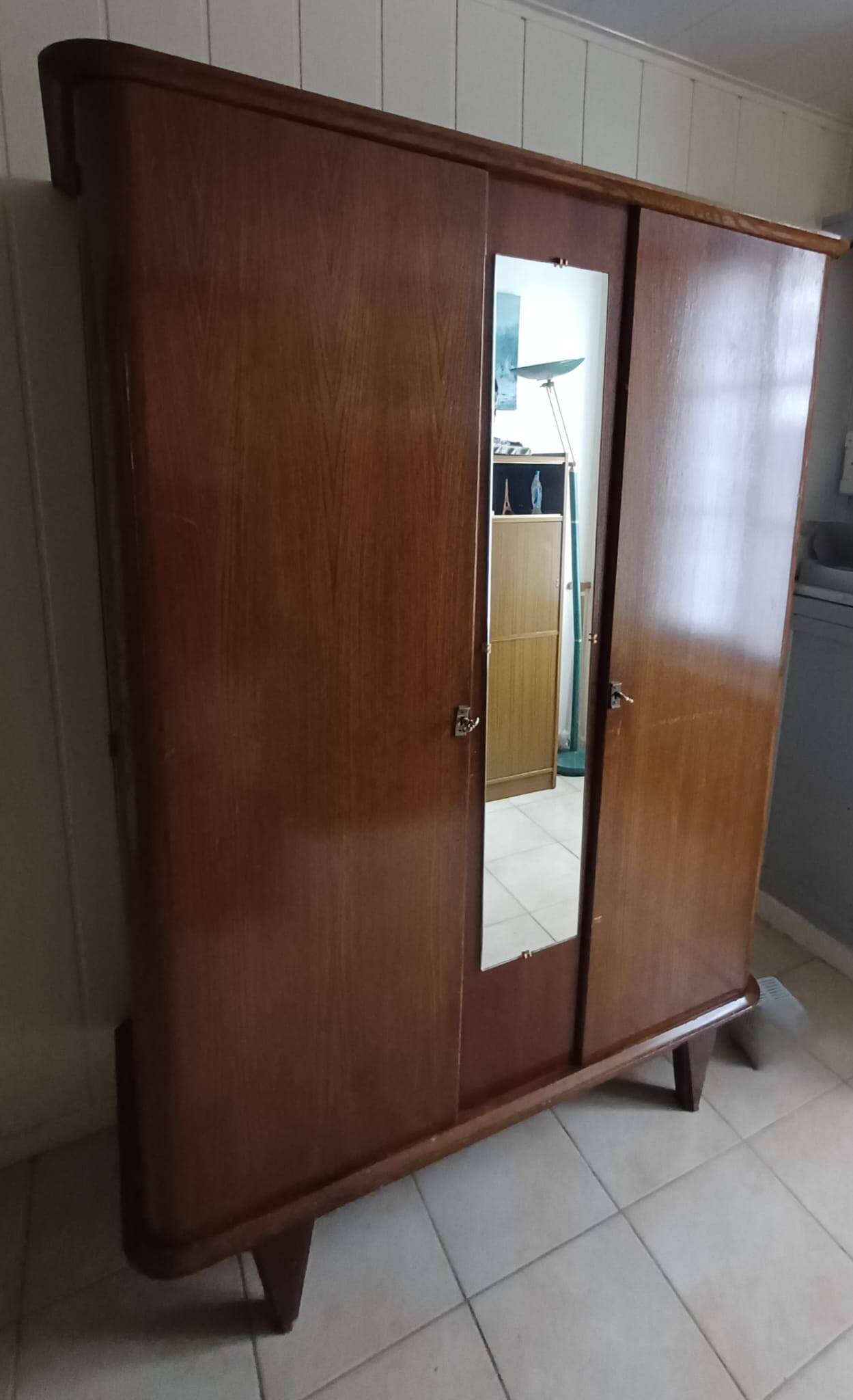 Vintage 1960s wooden wardrobe with a central mirror and tapered legs.